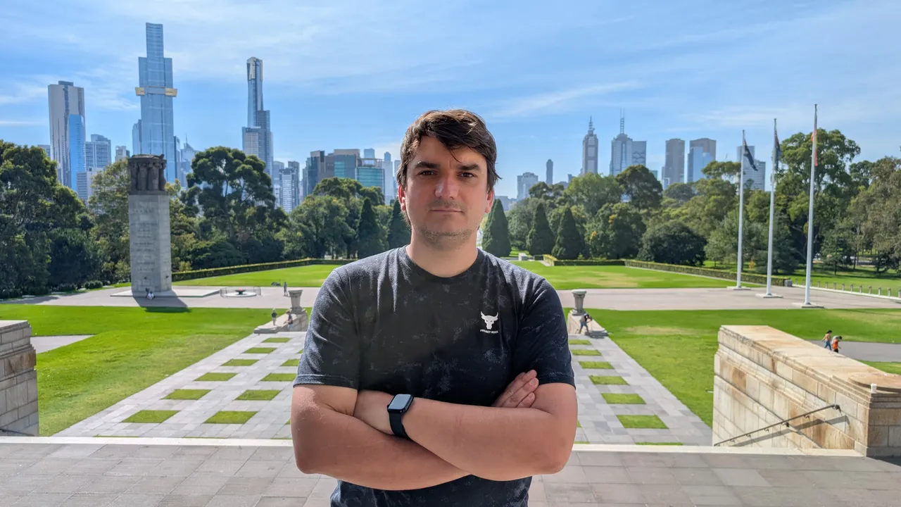 Oleh Sypiahin standing in front of the Melbourne city skyline